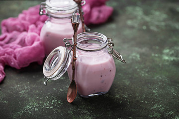 Sweet yogurt with berry in a glass jars