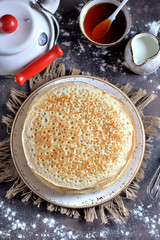 Russian traditional pancakes on milk with yeast.