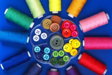 background with colored buttons and sewing thread
