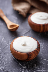 White Greek yogurt in wooden bowl
