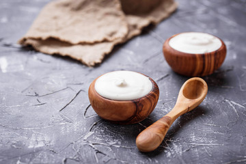 White Greek yogurt in wooden bowl