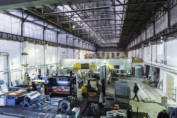 Fototapeta premium Industrial workshop or hangar on production of ventilation systems. Metalworking factory abstract background with lots of equipment and machinery