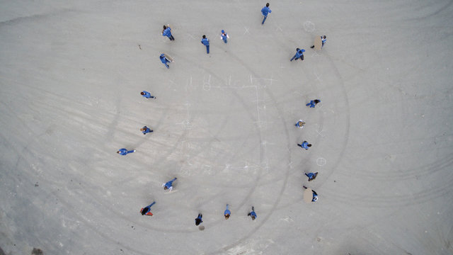 Top view on people doing a flash mob. Clip. A group of people making a figure out of their bodies. the Concept of society