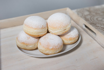 Donuts on plate on woode board
