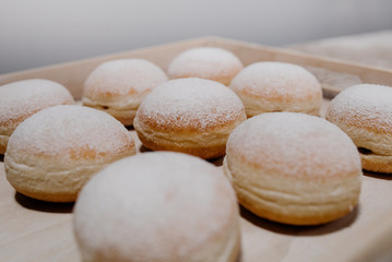Donuts on plate on woode board