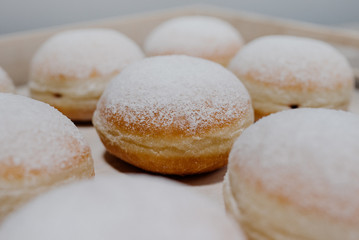 Donuts on plate on woode board