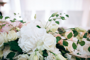 Wedding reception white table arrangement, floral centerpiece decoration, food. Catering service.