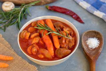 Spicy turkey goulash with mushrooms and carrots in tomato sauce.