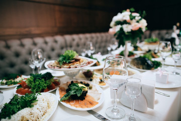 Catering service. Restaurant table with food and flower decoration. 