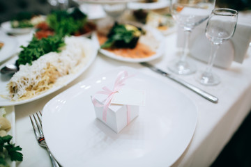 catering table wedding set  with silverware and glass, food and flower decoration