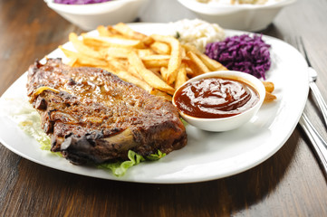 baked ribs and French fries and cabbage salad