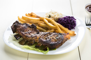 baked ribs and French fries and cabbage salad