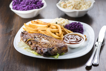 baked ribs and French fries and cabbage salad