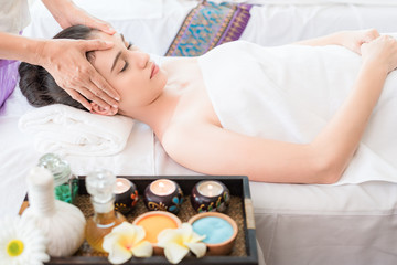 Obraz na płótnie Canvas Young healthy asian woman lying relax in spa salon.Traditional Thai oriental aromatherapy and Massage beauty treatments.Recreation vitality wellness wellbeing resort hotel lifestyle leisure