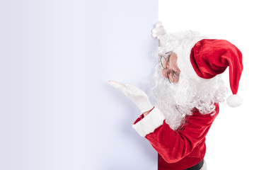 Santa Claus pointing in white blank sign with smile, isolated on white background. .copy space for Advertising christmas and happy new year festival