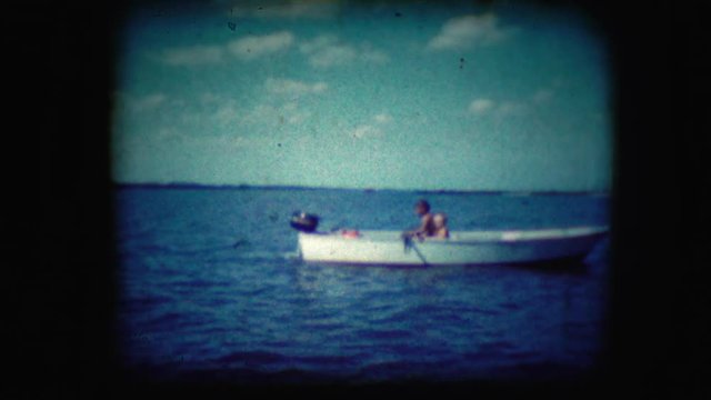 Archival footage of boys rowing a boat
