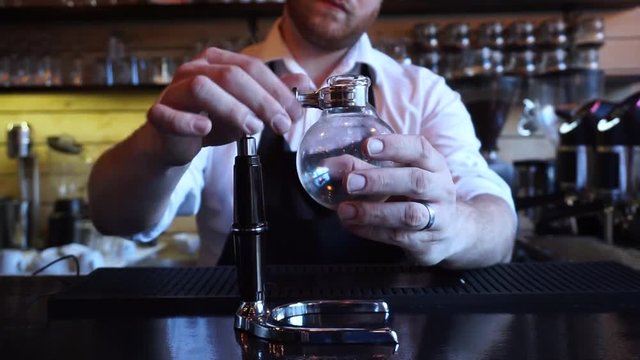 Barista preparing to make Syphon alternative coffee brewing style