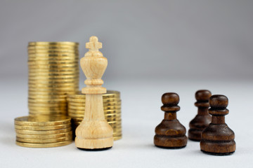chess pieces piles of gold coins crisis intervention concept
