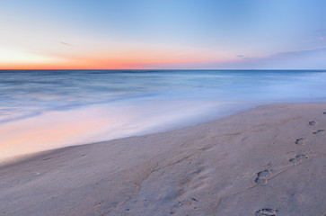 Footprints on Virginia Beach before sunrise, Virginia, USA