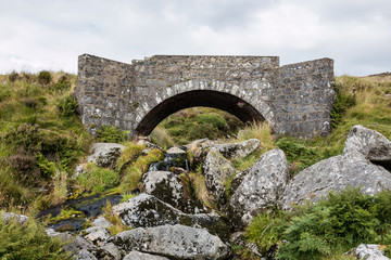 Fototapeta na wymiar Old stone bridge crossing a river in Wicklow Mountains, Ireland