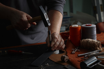 Man working with leather using crafting DIY tools