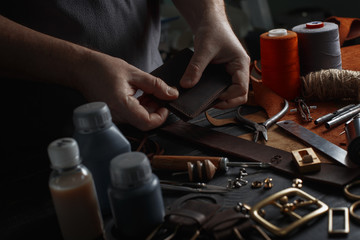 Man working with leather using crafting DIY tools