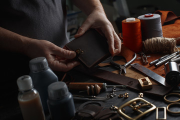 Man working with leather using crafting DIY tools