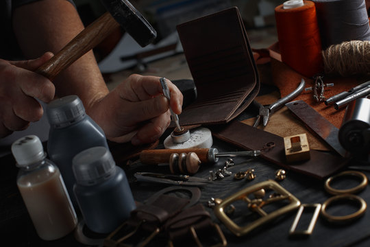 Man working with leather using crafting DIY tools