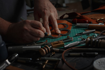 Man working with leather using crafting DIY tools