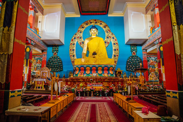 ELISTA, KALMYKIA, RUSSIA - APRIL 24, 2017: Buddhist temple interior. Statue of seated Buddha in the Temple Golden Abode of Buddha Shakyamuni 