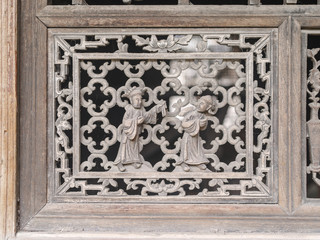 Chinese Traditional wood carvings, disused wood windows covered with dust, beautiful wood carvings of Chinese traditional legend story.