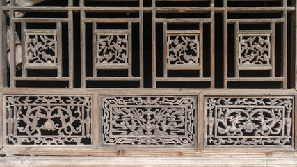 Chinese Traditional wood carvings, disused wood windows covered with dust, beautiful wood carvings of Chinese traditional legend story.
