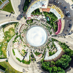 Aerial city view with crossroads and roads, houses, buildings, parks and parking lots, bridges. Helicopter drone shot. Wide Panoramic image.