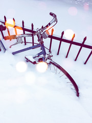 Bicycle in snow, with bokeh light effect