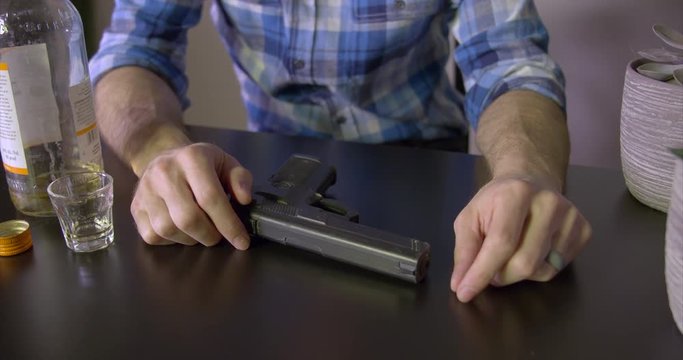 Depressed man contemplates suicide with gun