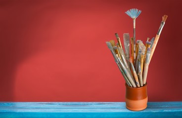 Brushes in a glass jar