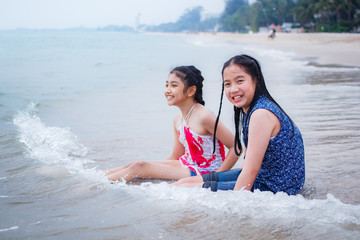 Obraz premium Two little girls are on the beach.
