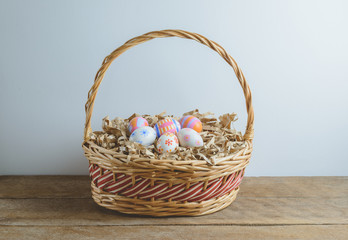 Fototapeta na wymiar colorful handmade easter eggs on Straw paper in basket