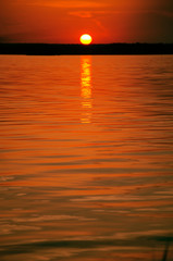 orange sunset over water and sun track background image