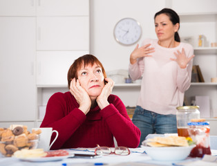 Two women having serious quarrel and talking
