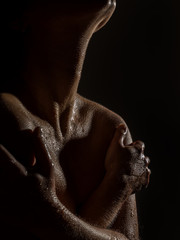 sexy nude female neck and shoulders with water drops on a black background