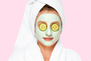 Beauty Treatments. Woman applying facial clay mask at spa