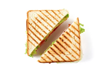 Wall murals Snack Sandwich with ham, cheese, tomatoes, lettuce, and toasted bread. Top view isolated on white background.