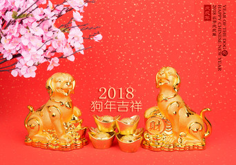 golden dog statue on red paper,translation of calligraphy: good Fortune for year of the dog,red stamp: year of the dog,2018 is year of the dog.