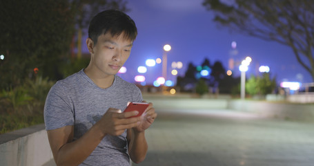 Fototapeta premium Man use of smart phone at night