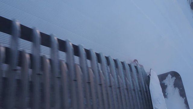 Footage of a snow groomer track as it climbs the mountain
