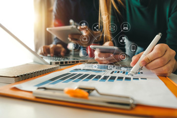 Business team meeting. Photo professional investor working new start up project. Finance task.Digital tablet docking keyboard laptop computer smart phone in morning light
