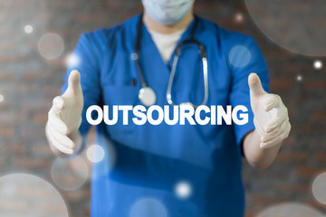 Doctor offers outsourcing text icon on a virtual interface. Outsourcing Offshoring Medical Hospital...