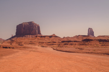 Journey to the wild West of the USA. Road in the rocky desert of the Valley of Monuments