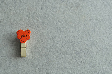 The word plus on a peg isolated on a white background